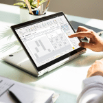 Image of a man using an example of the Power BI templates on a laptop.